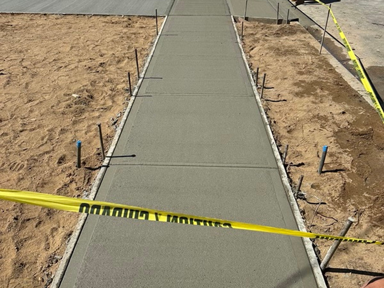 Rebar-reinforced concrete pour for a sidewalk section